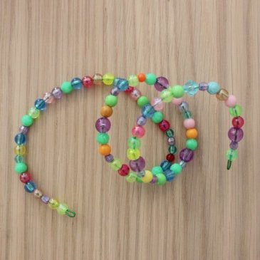 Make a bracelet out of beads with your kid 