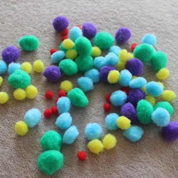 Playing with multicolored pompoms