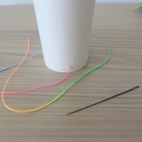 Activity picture for Decorate a cup with colored fishing line in Wachanga